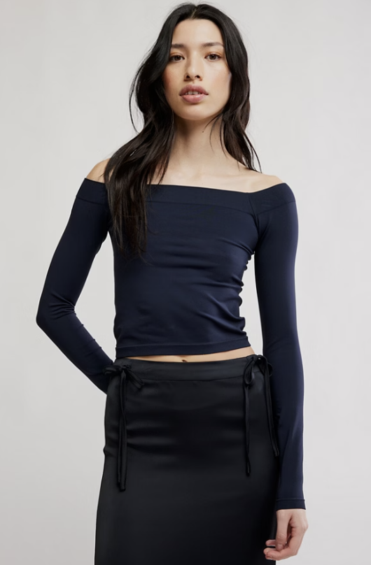 Woman wearing black shirt and black skirt on white background