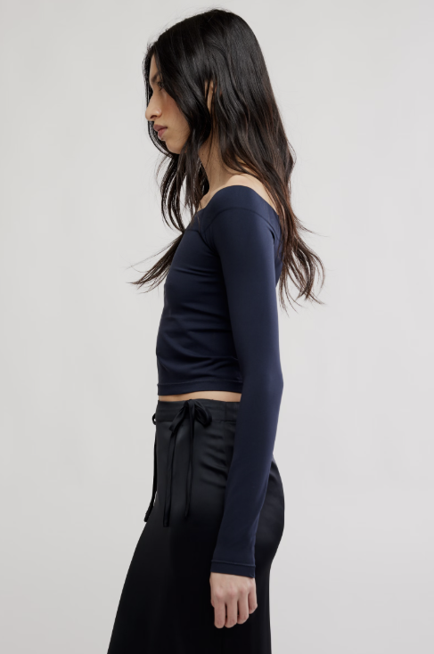 Woman wearing black shirt and black skirt on white background