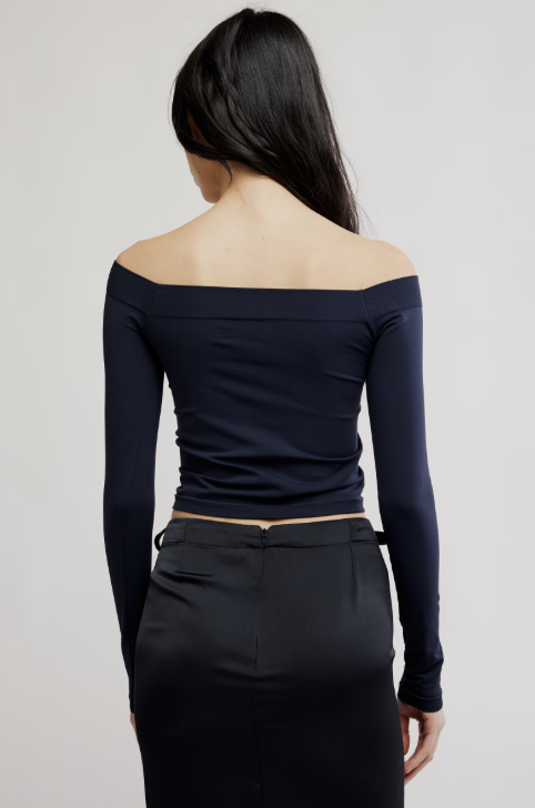 Woman wearing black shirt and black skirt on white background