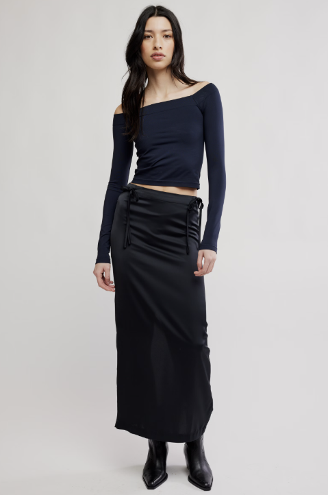 Woman wearing black shirt and skirt on white background