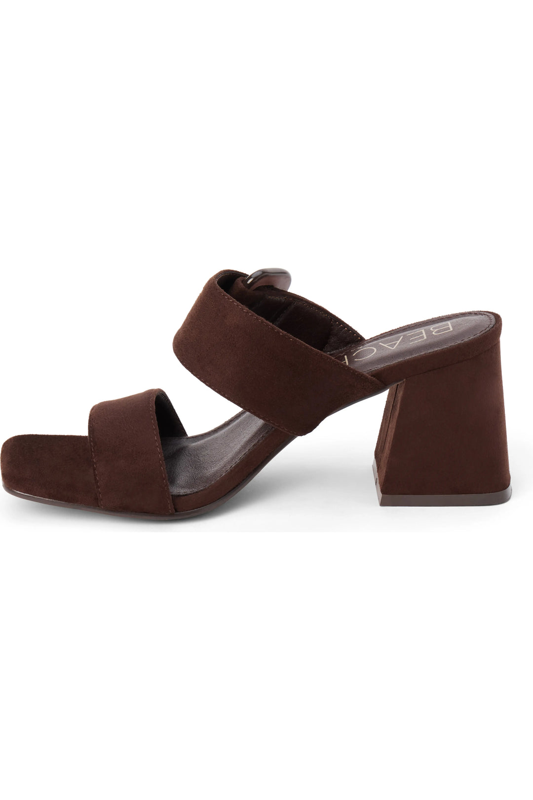 A dark brown suede mule sandal with a chunky block heel and double straps, shown from a side profile on a white background.