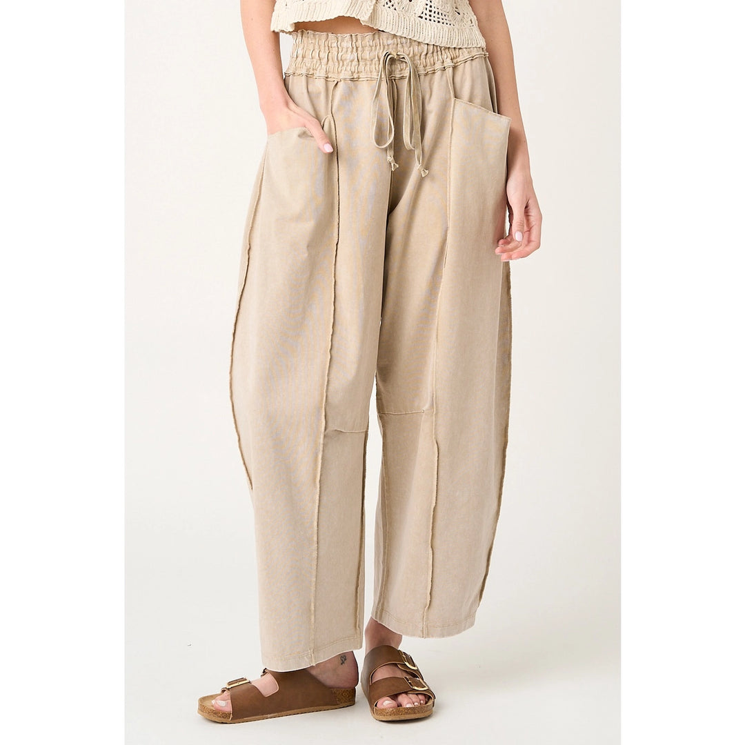 Beige wide-leg pants worn by a person on a white background