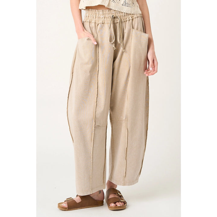 Beige wide-leg pants worn by a person on a white background