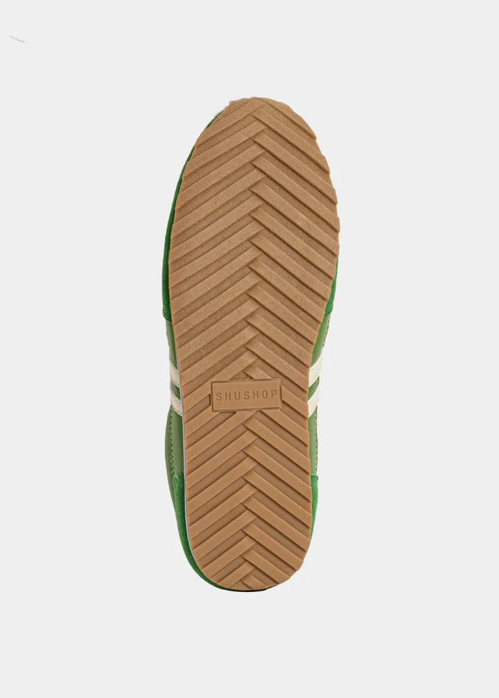 Close-up of a shoe sole with a brand logo on a white background