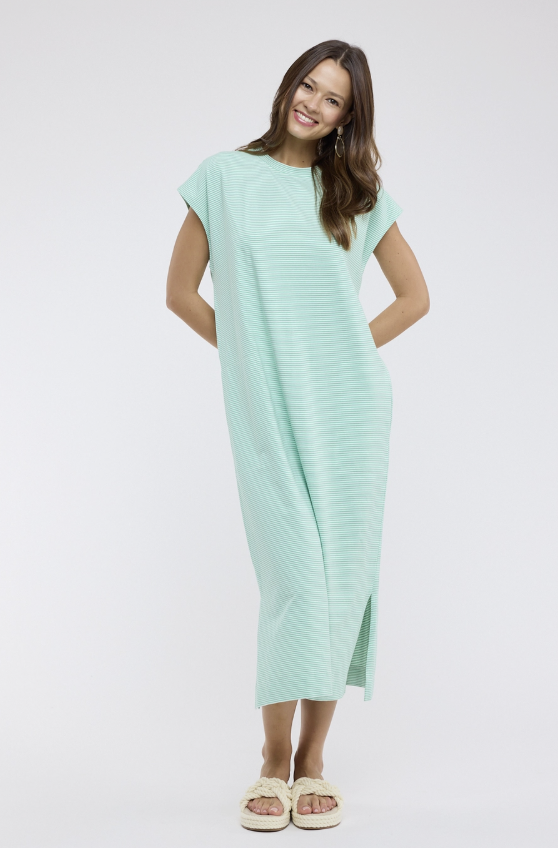 Woman wearing a light green dress on a white background