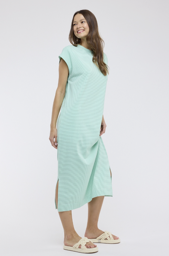 Woman wearing a light green dress on a white background