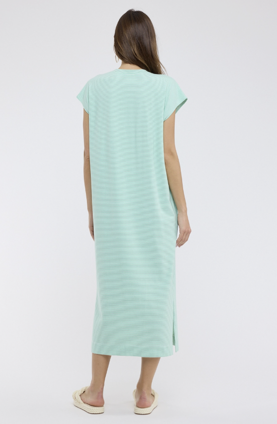 Woman wearing a light green dress on a white background