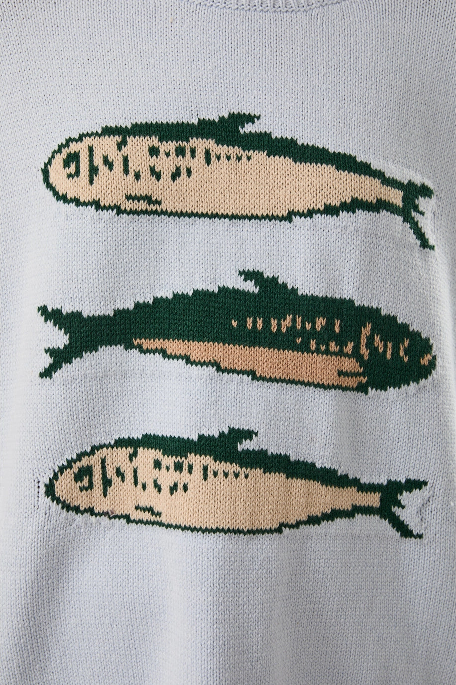 Close up of light blue sweater with sardine graphic