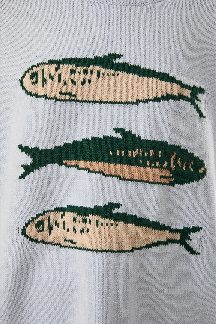 Close up of light blue sweater with sardine graphic