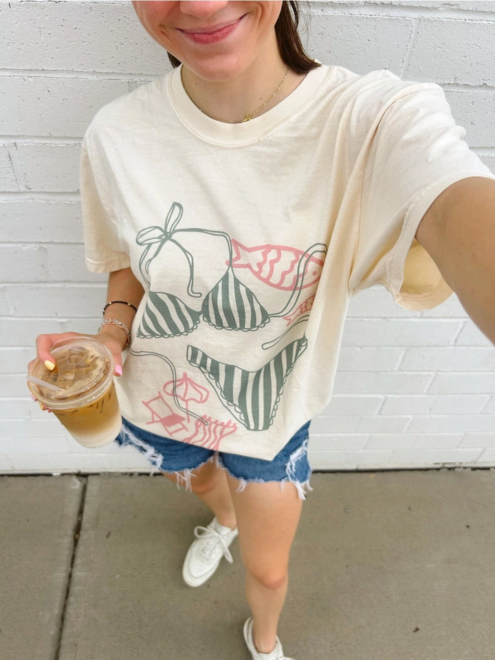 Woman wearing graphic tee with bikini designs