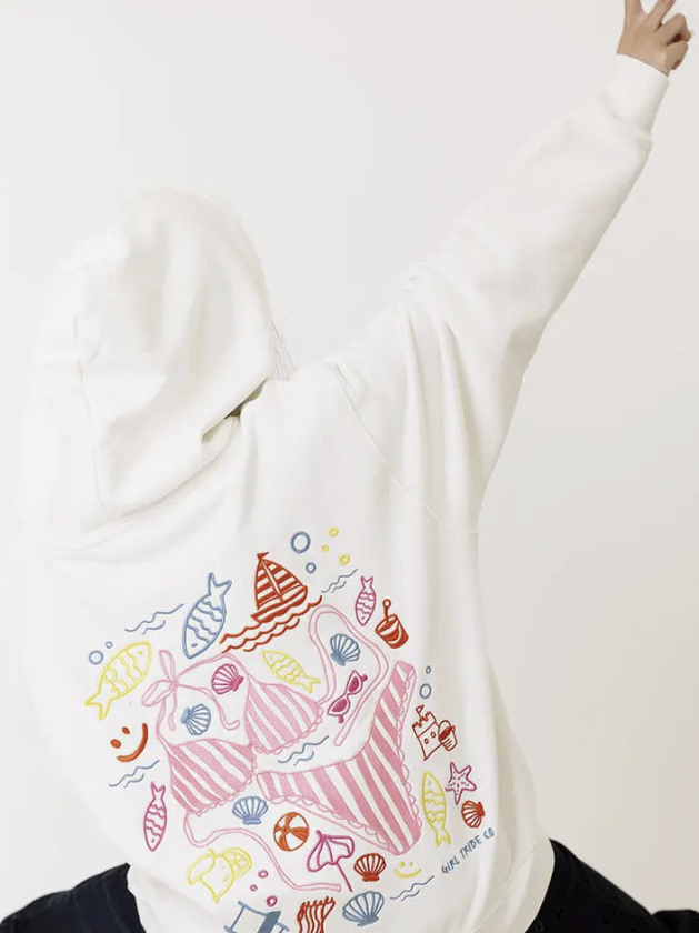 White sweatshirt with colorful mermaid-themed design on a plain background