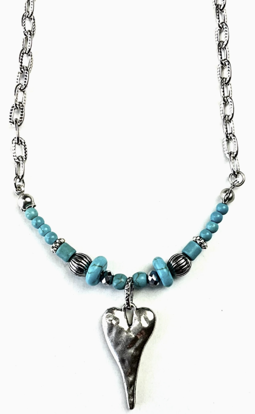 Silver and turquoise beaded necklace with hammered heart pendant on white background