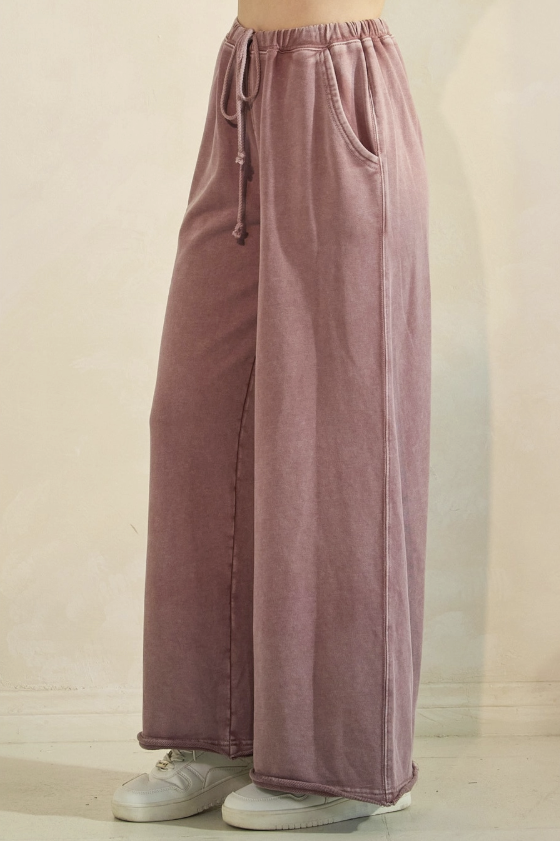 Mauve wide-leg pants with a drawstring waist on a beige background