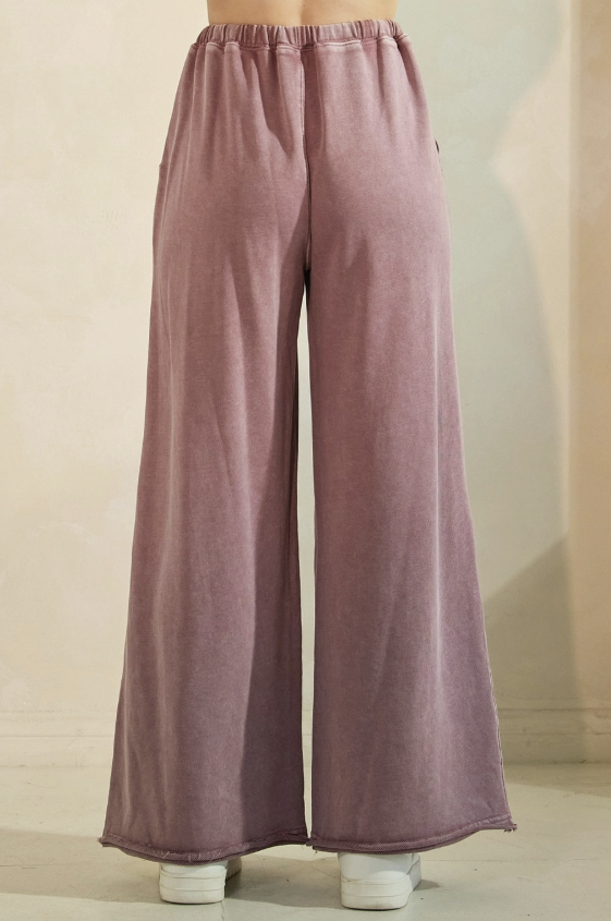 Purple wide-leg pants on a neutral background