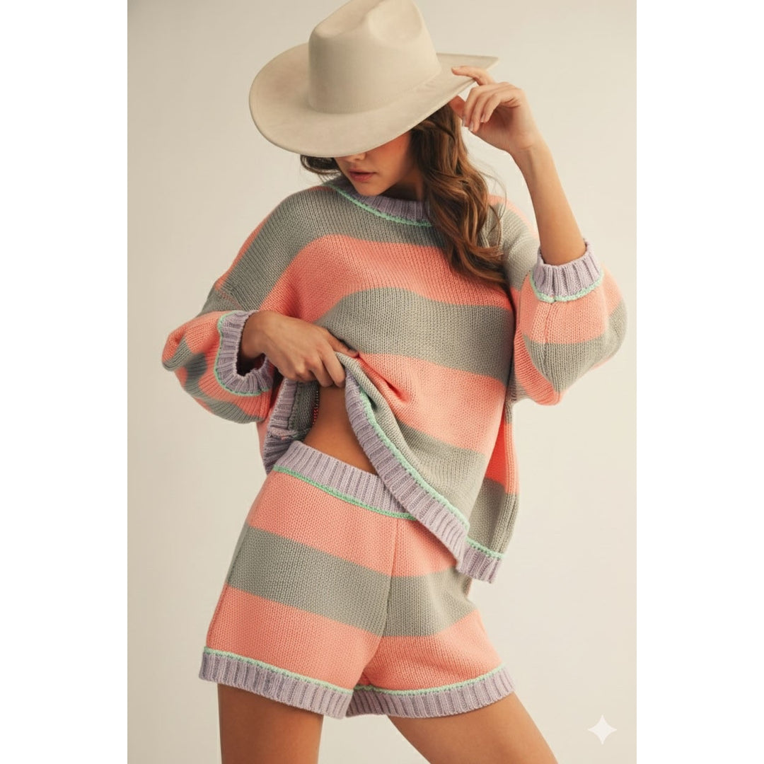Woman wearing grey and coral matching set on plain background