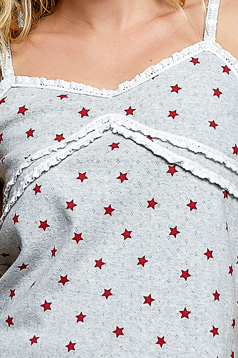 Gray tank top with red star pattern worn by a person