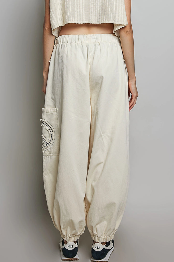 Beige cargo pants worn by a person on a plain background