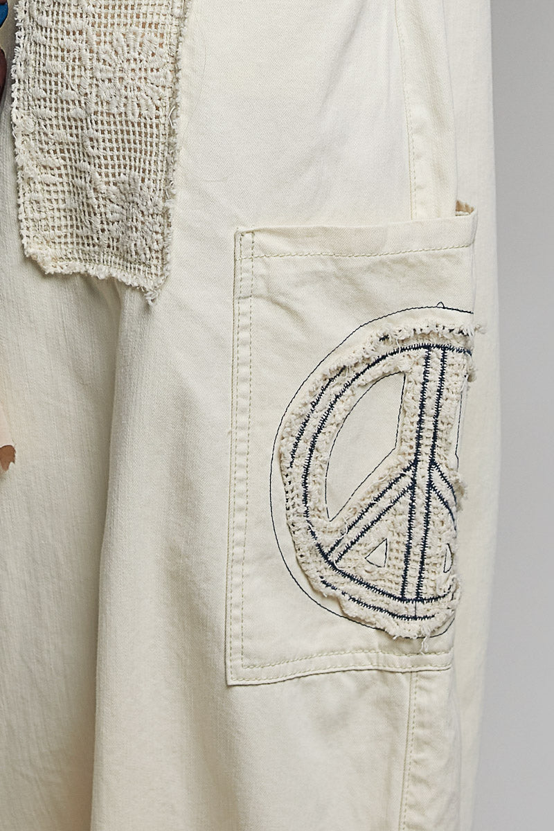 Close up of beige pants on plain background