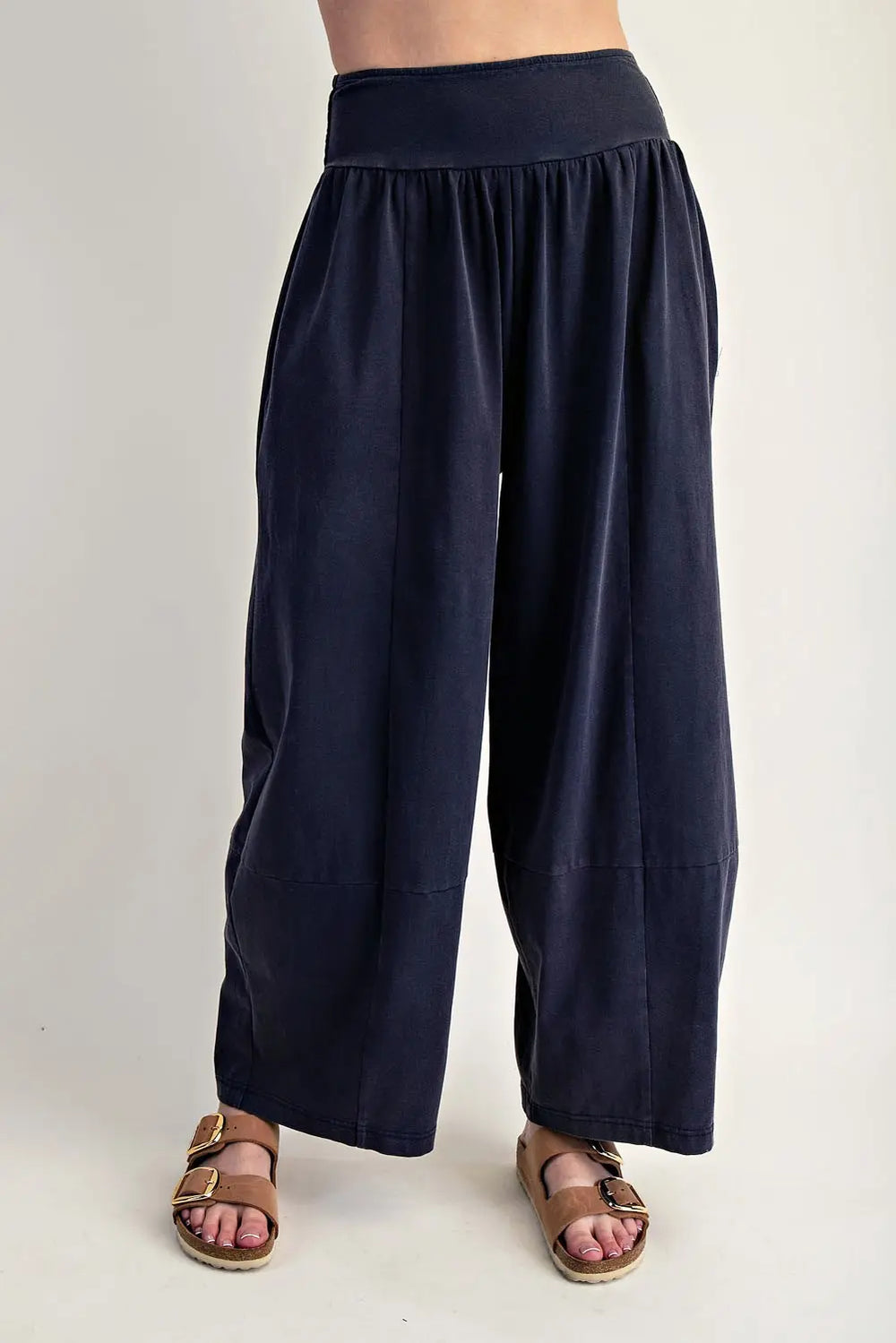 Navy blue wide-leg pants worn by a person on a plain background