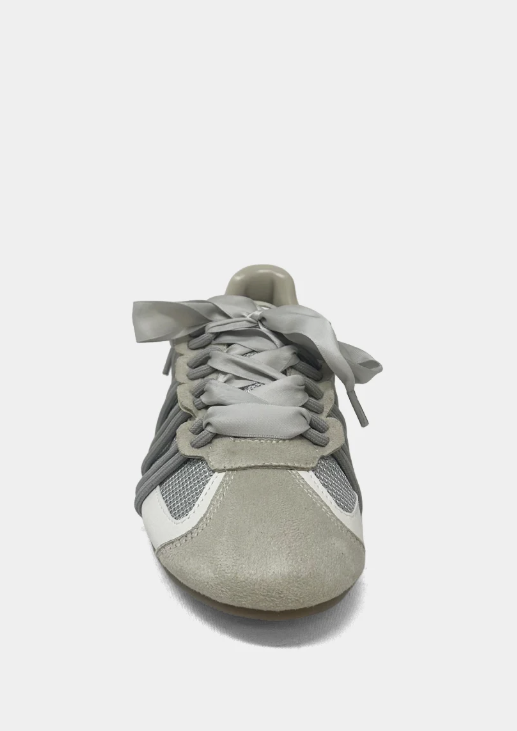 Gray sneaker with white laces on a light gray background