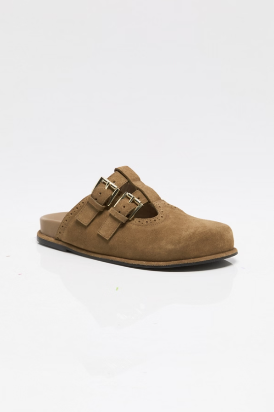 Tan suede mule with buckle detail on white background