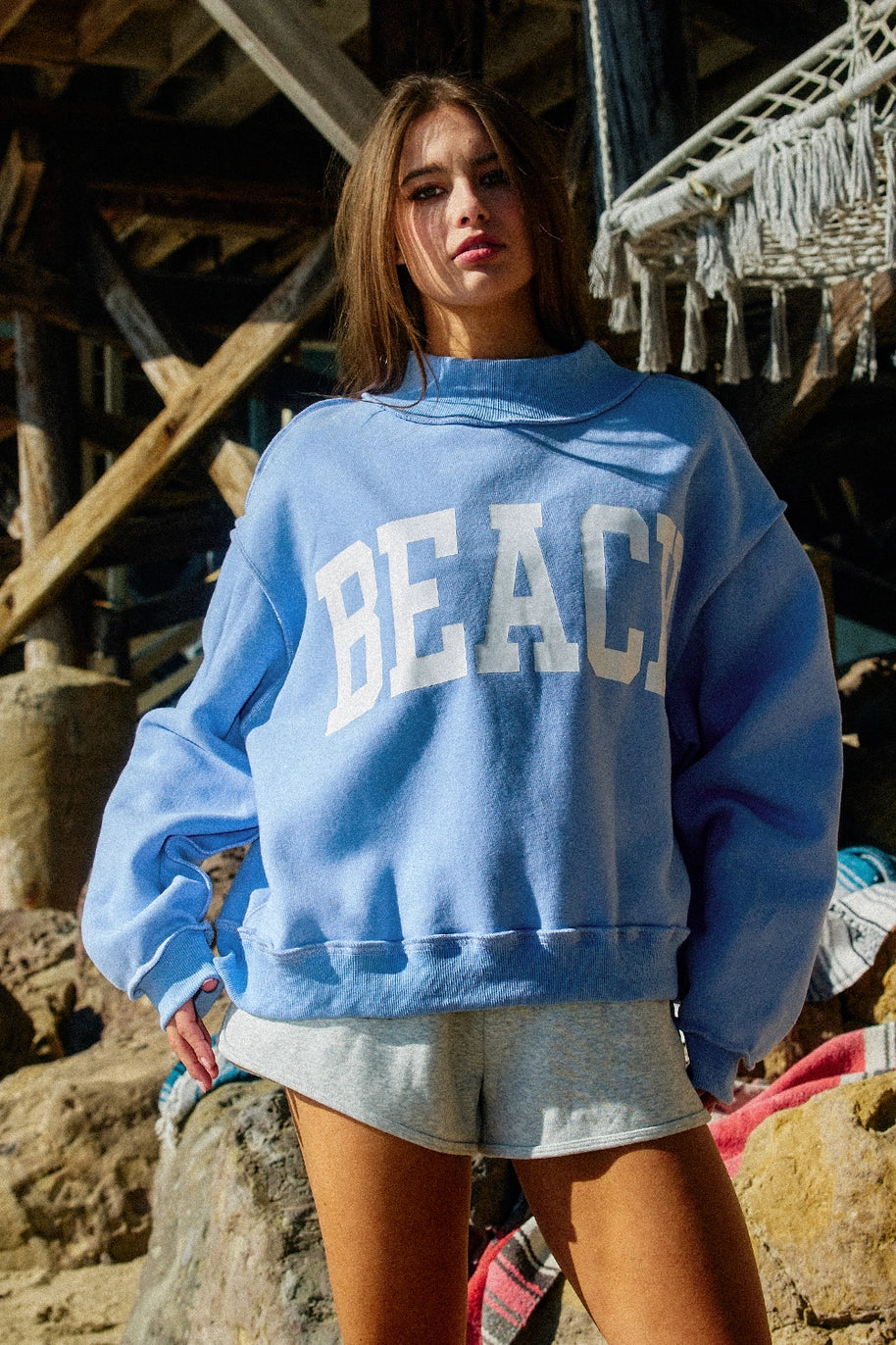 Woman wearing blue sweatshirt with &