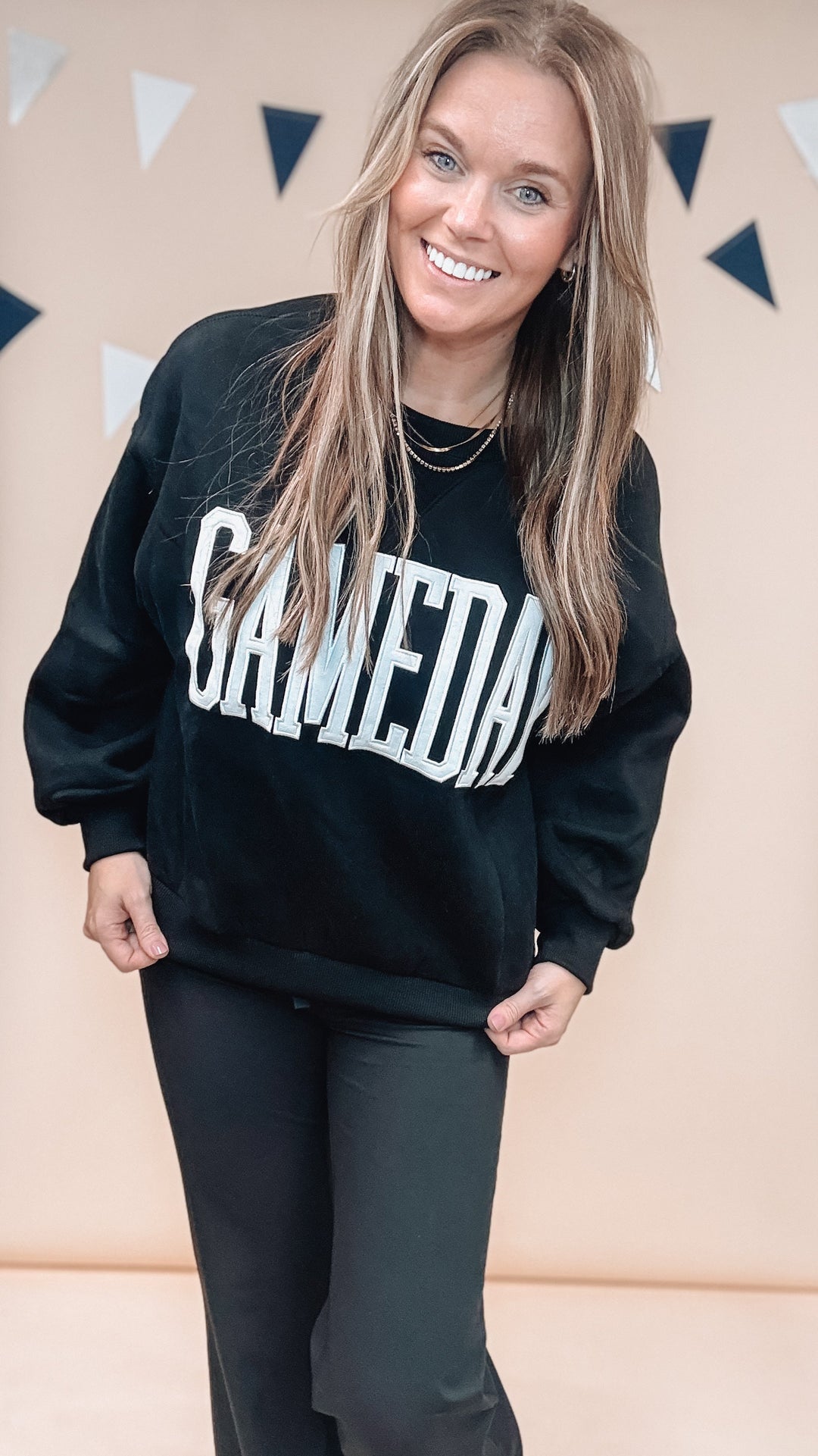 Woman wearing black sweatshirt with &