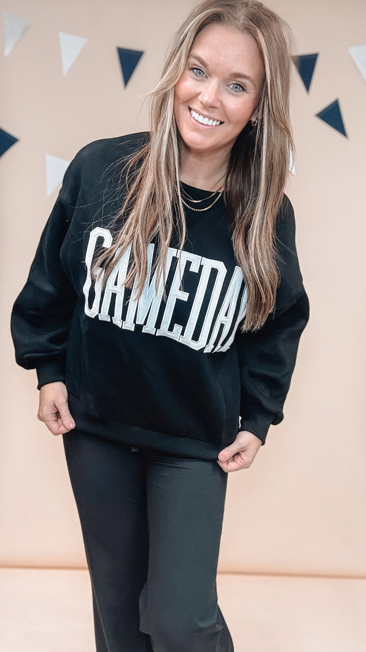 Woman wearing black sweatshirt with &