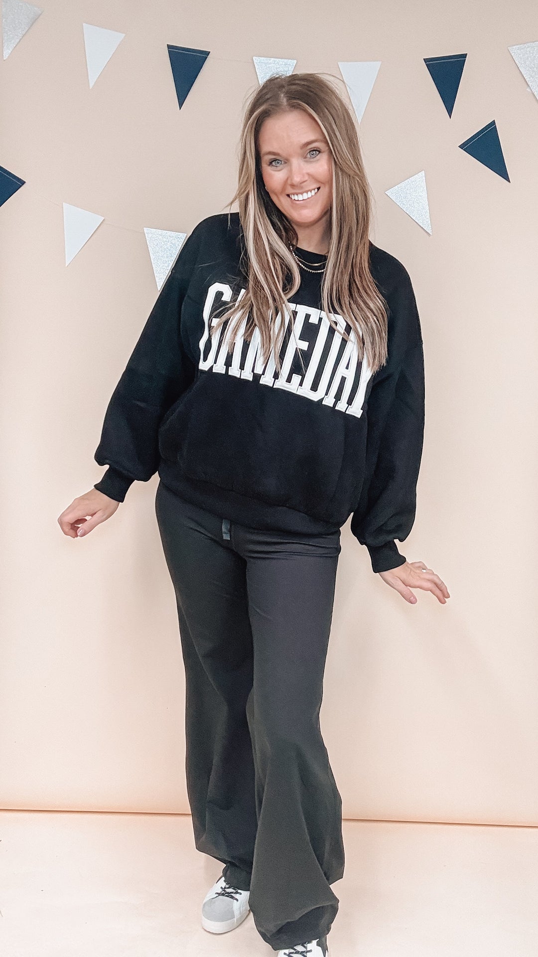 Woman wearing black sweatshirt with &