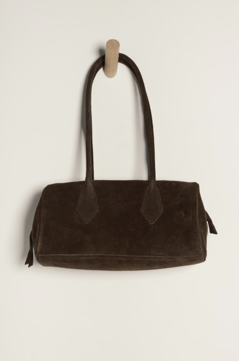 Brown velvet handbag on a white background