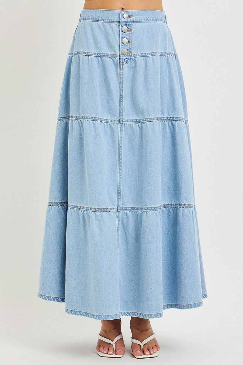 woman wearing denim maxi skirt on plain background