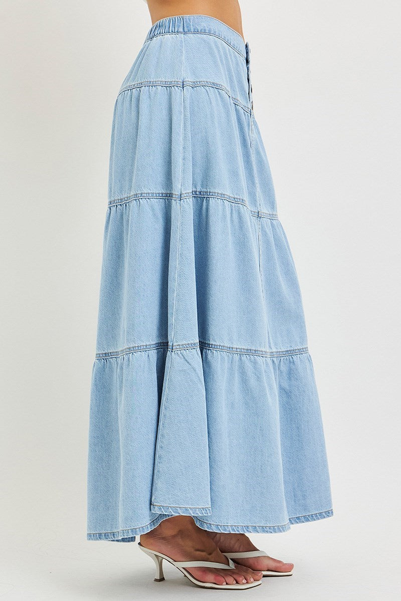 woman wearing denim maxi skirt on plain background