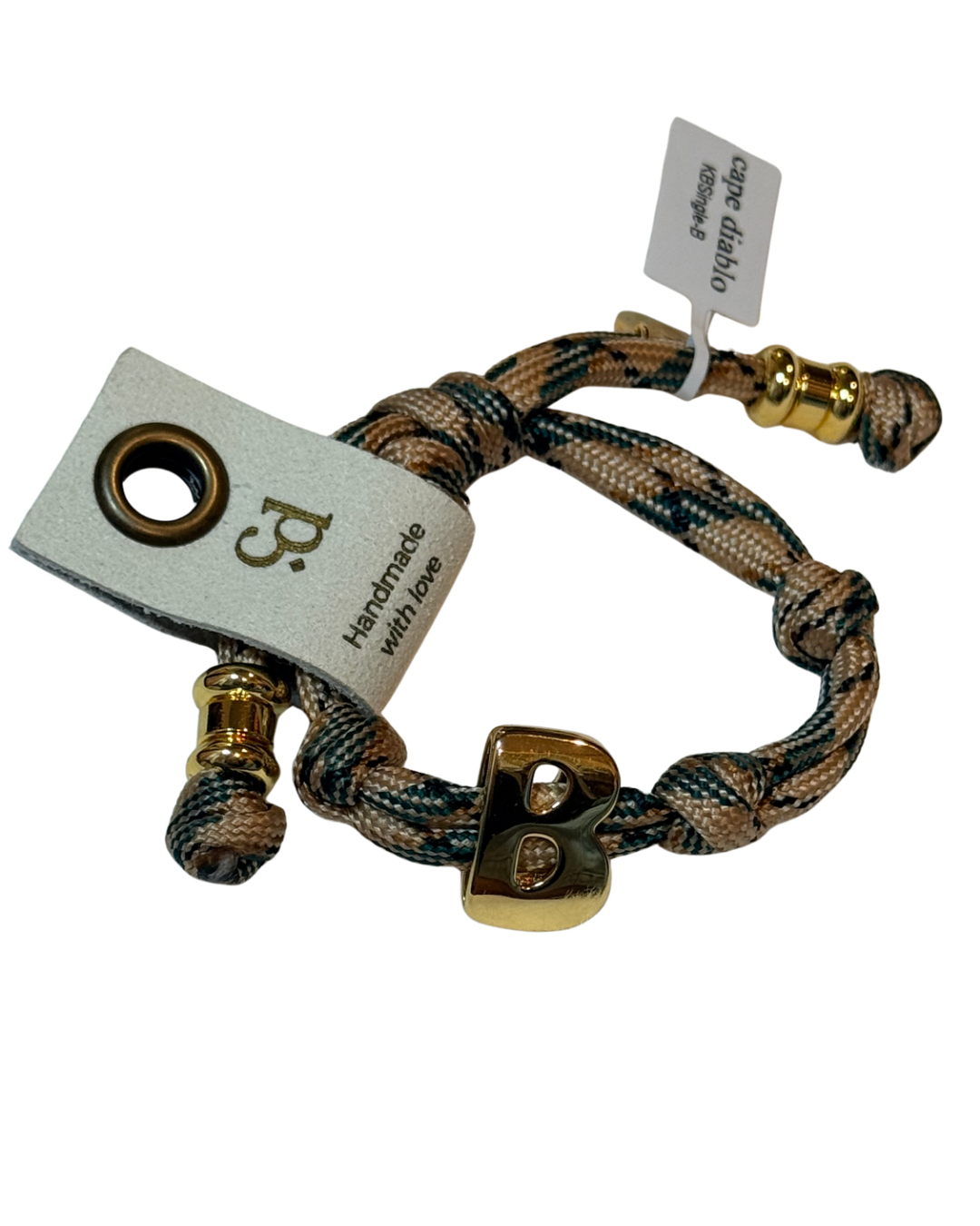 Cord Bracelet with gold accents on plain background