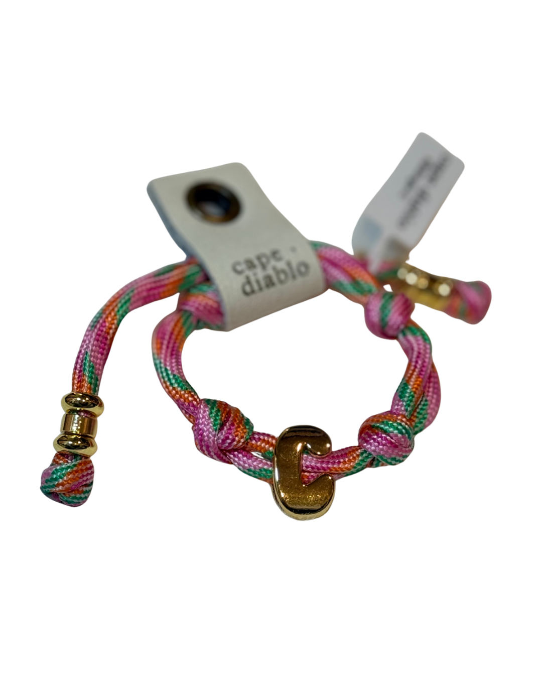 Cord bracelet with gold accents on plain background