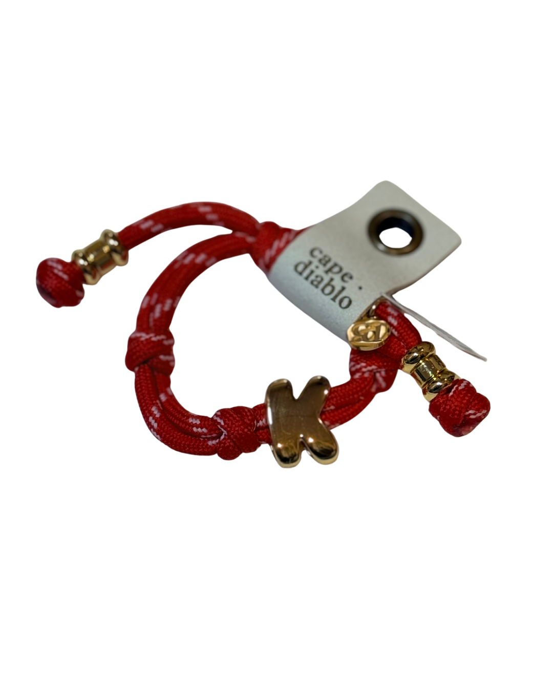 Red bracelet with gold accents on a white background, featuring a 'Cape Diablo' tag.