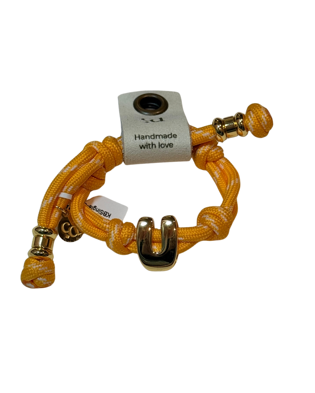 Yellow braided bracelet with gold accents on a white background