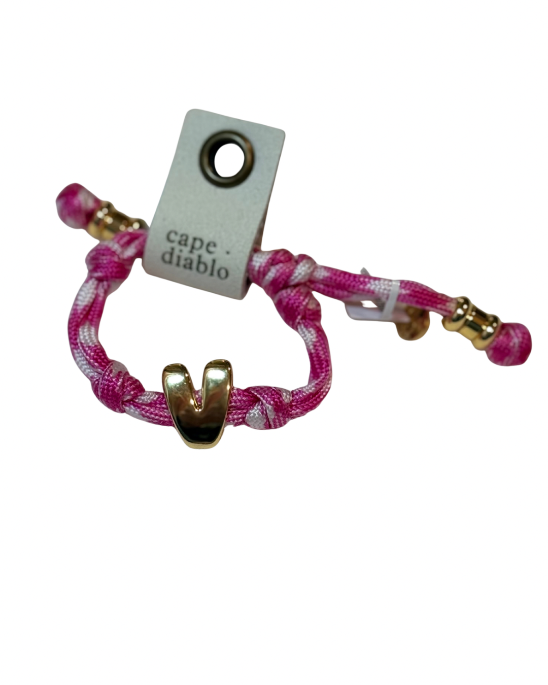 Cord bracelet with gold accents on plain background