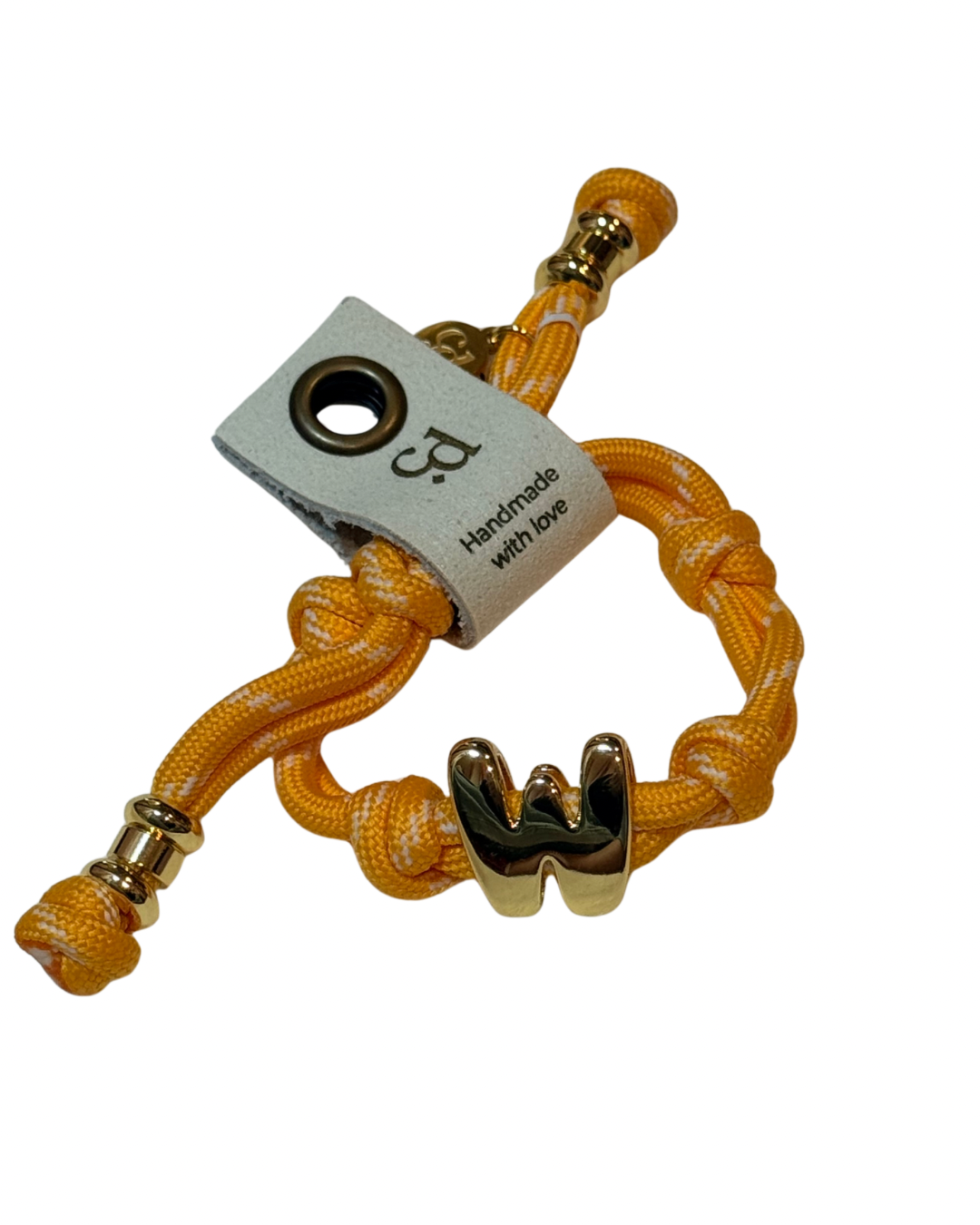 Yellow braided bracelet with gold accents on a white background