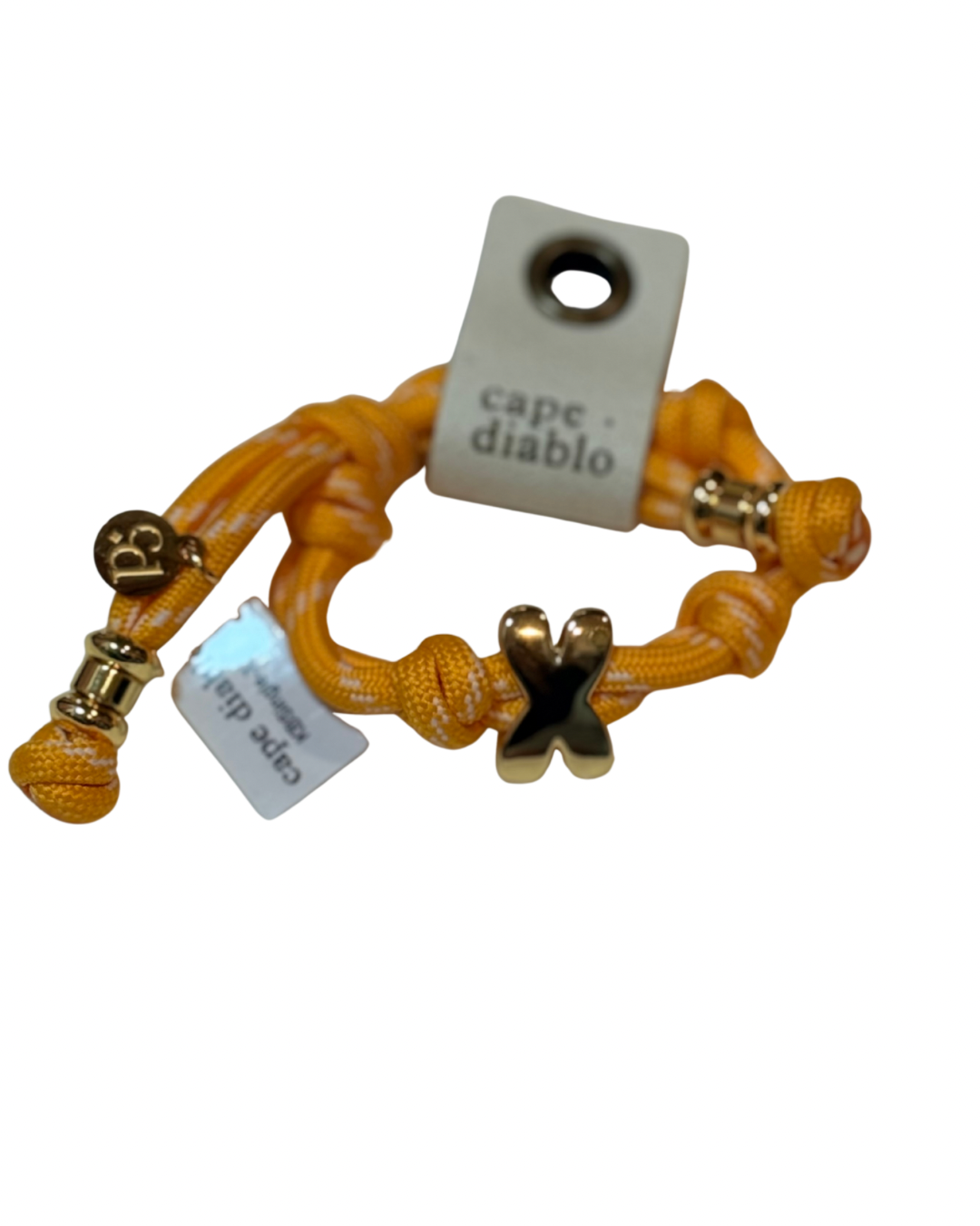 Cord bracelet with gold accents on plain background