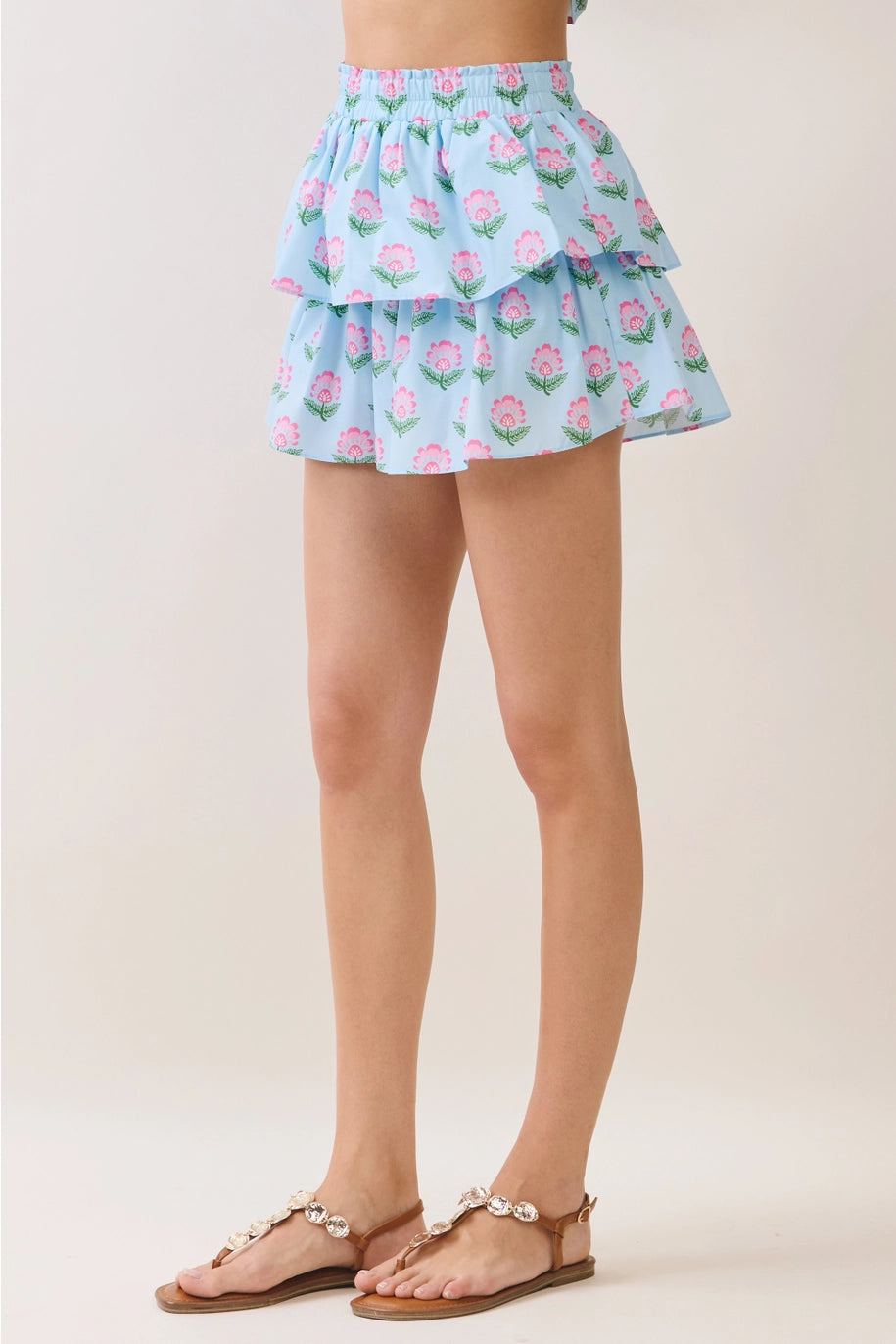 Light blue floral skirt worn by a person on a plain background
