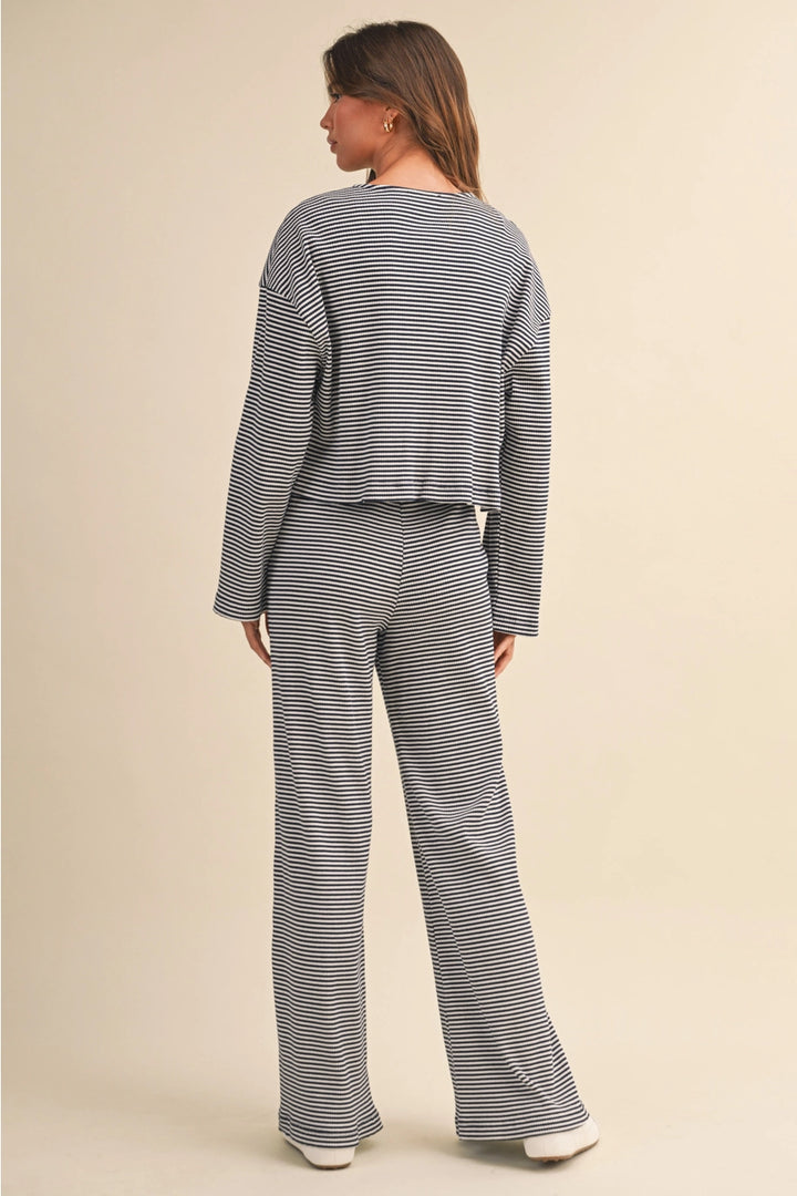 Woman wearing a striped outfit on a beige background