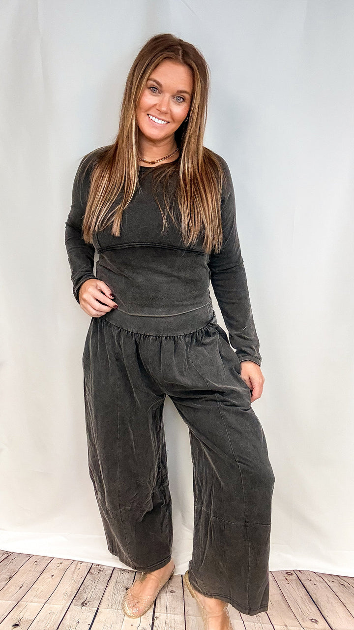Woman wearing matching black set on white background
