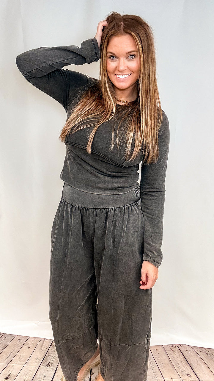 Woman wearing matching black set on plain background