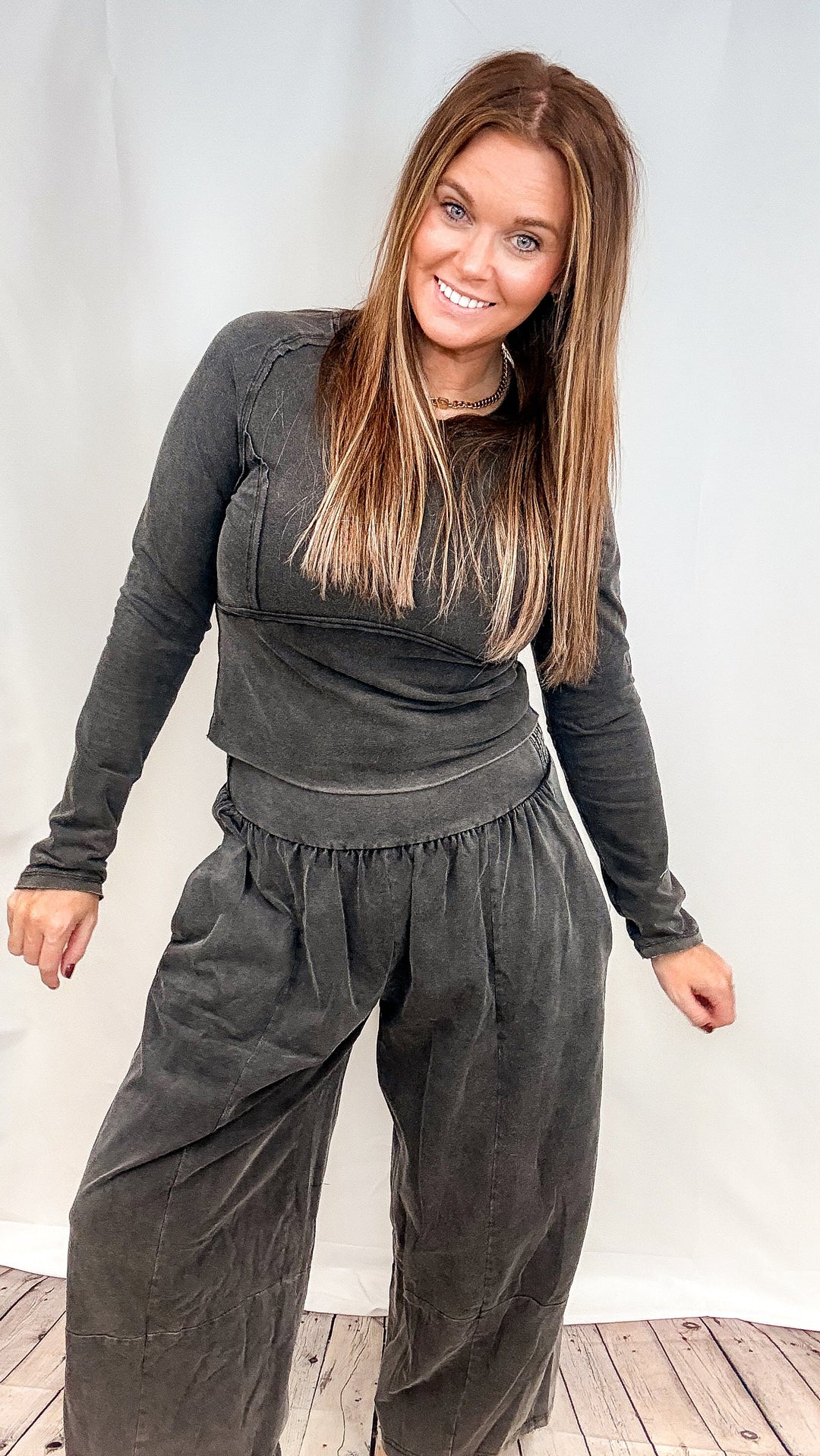 Woman wearing matching black set on plain white background