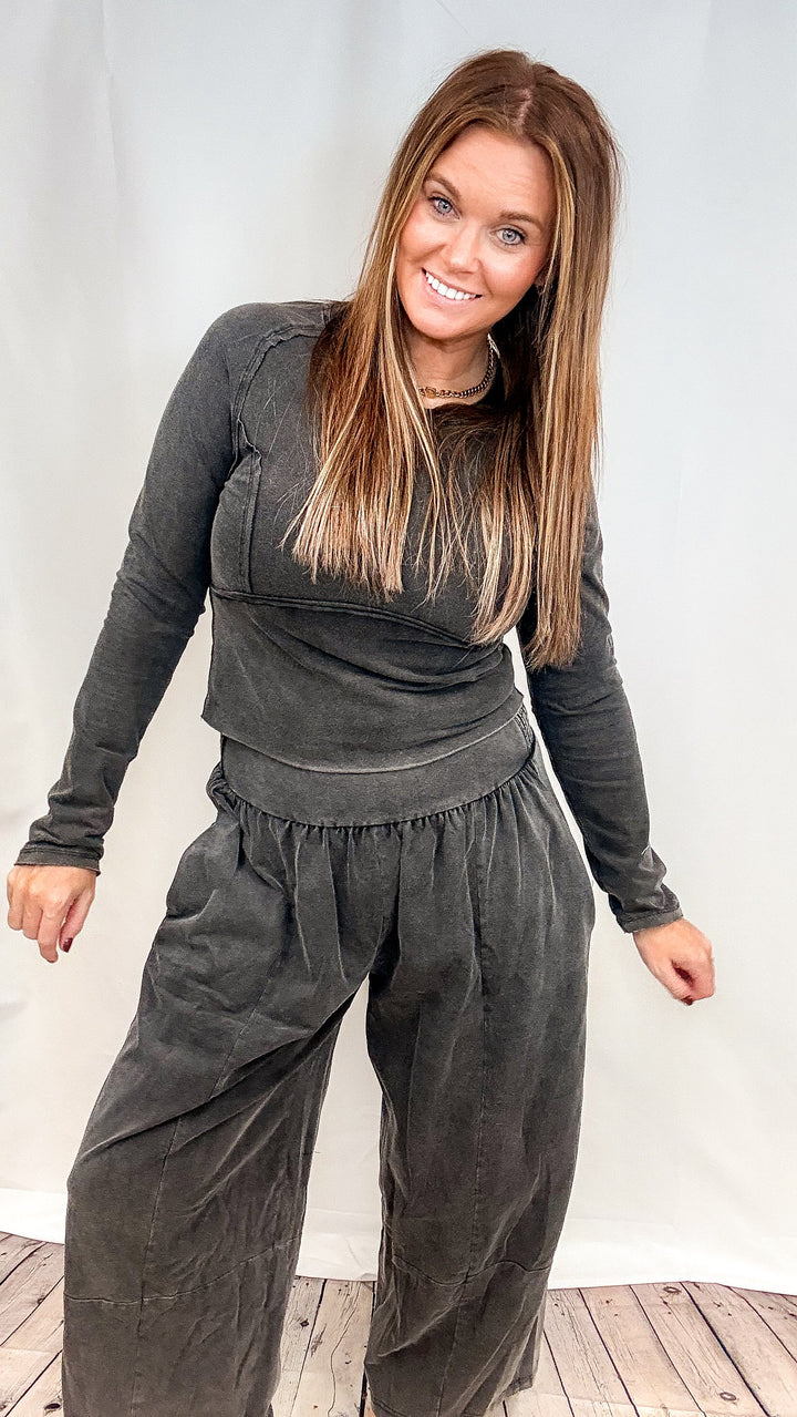 Woman wearing matching black set on plain white background