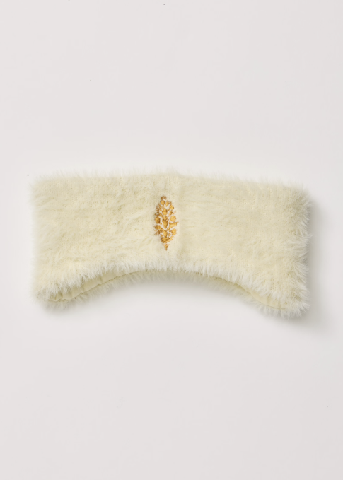 Cream sherpa headband with yellow logo on white background