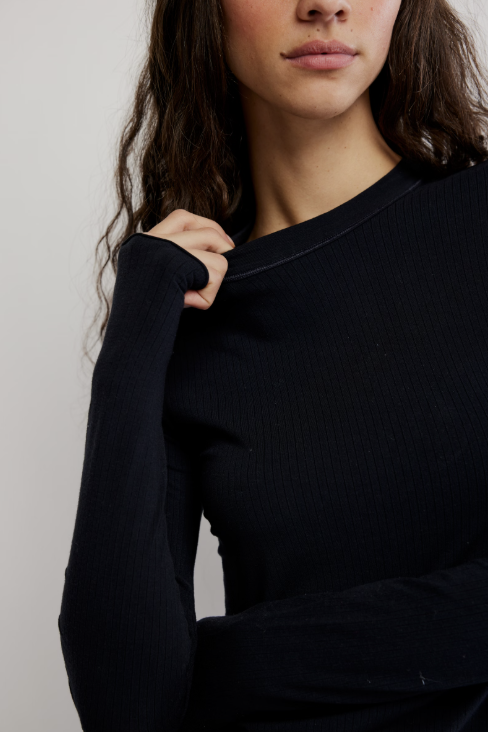 Close up of long sleeve ribbed black tee on white background