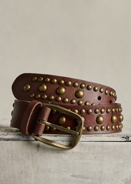 Brown studded belt with gold accents on plain background