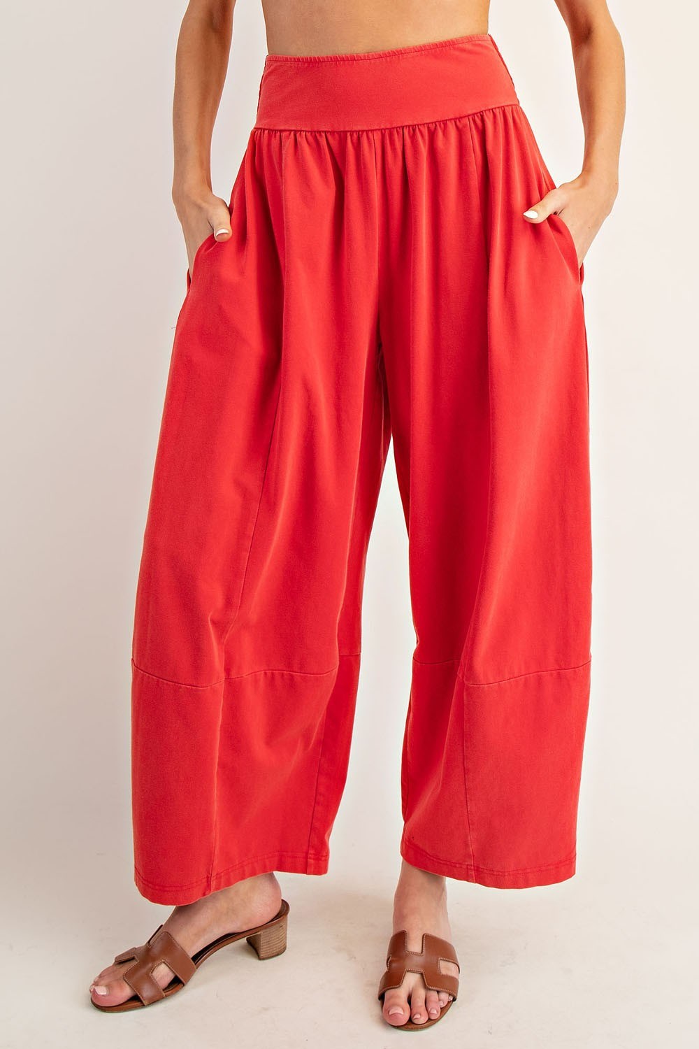 Red wide-leg pants worn by a person on a plain background