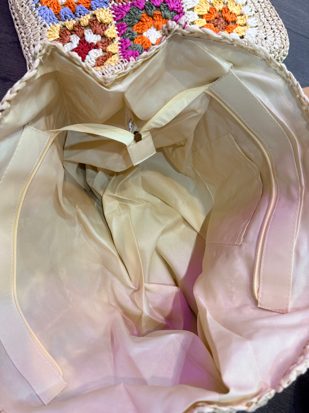 Beige bag with floral-patterned fabric underneath